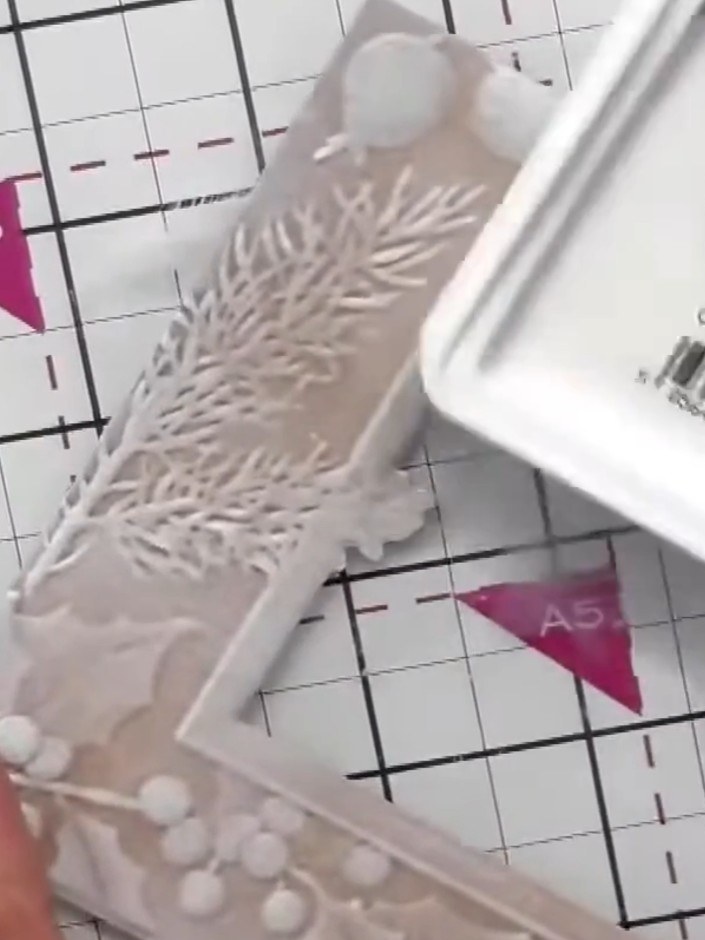 Step 3: Using white pigment ink, tap the ink pad directly onto the raised embossed areas of the design to highlight th