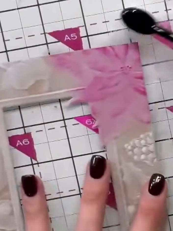 Step 5: Use a blending brush to soften and blend the pink ink outward from the flower centre, creating a gentle gradie