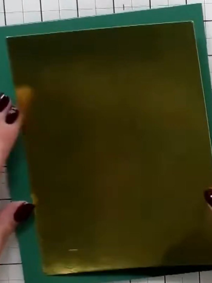 Step 6: Mount the stamped wildlife panel onto a teal card blank using adhesive. Ensure the panel is centred on the car