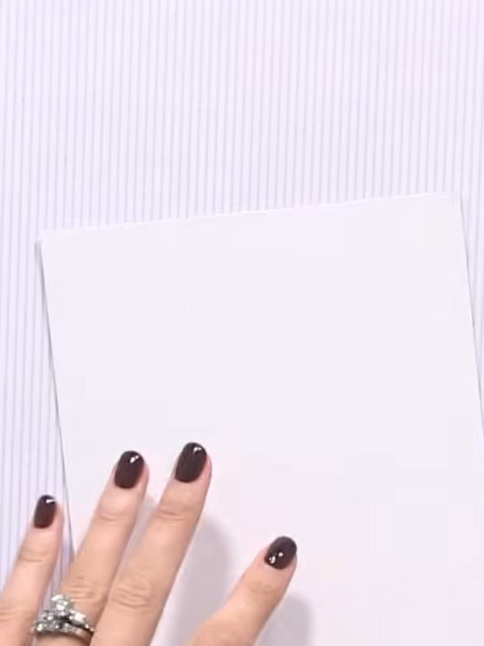 Step 2: Score the white card at the halfway point (approximately 3 inches) on one side using your scoring tool and rul