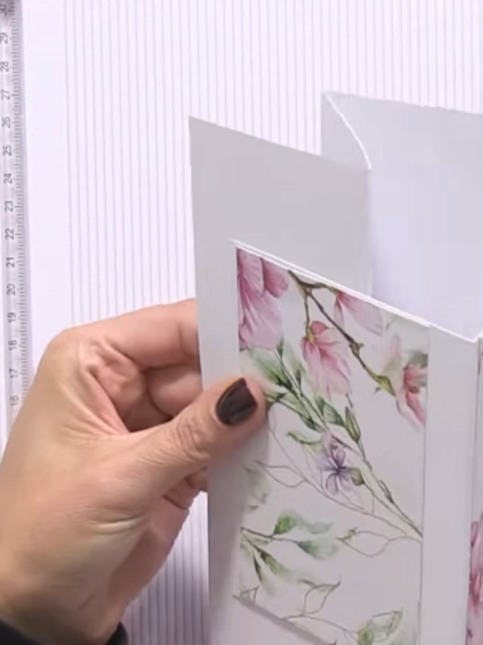 Step 3: Apply double-sided tape or glue to the back of your first decorative panel. Position and adhere it to one side