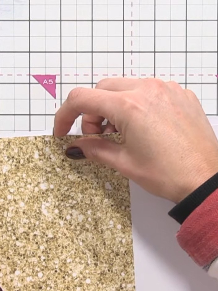 Step 6: Position and adhere the gold glitter card panels to the left side of the card front and the bottom right corne