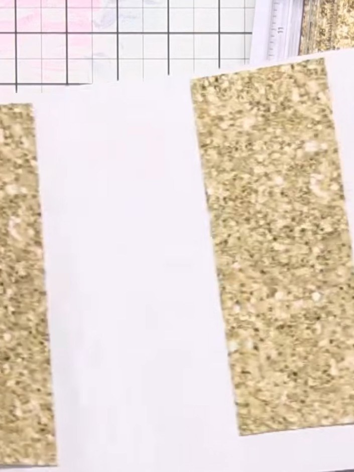 Step 9: Adhere the gold glitter panels to the back of the card to create a coordinated striped design. Position them t