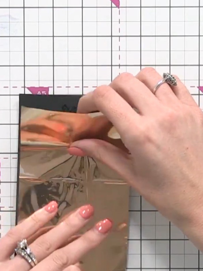 Step 6: Place your foil sheet on top of the heated bonding powder, ensuring it covers the stamped design completely. T