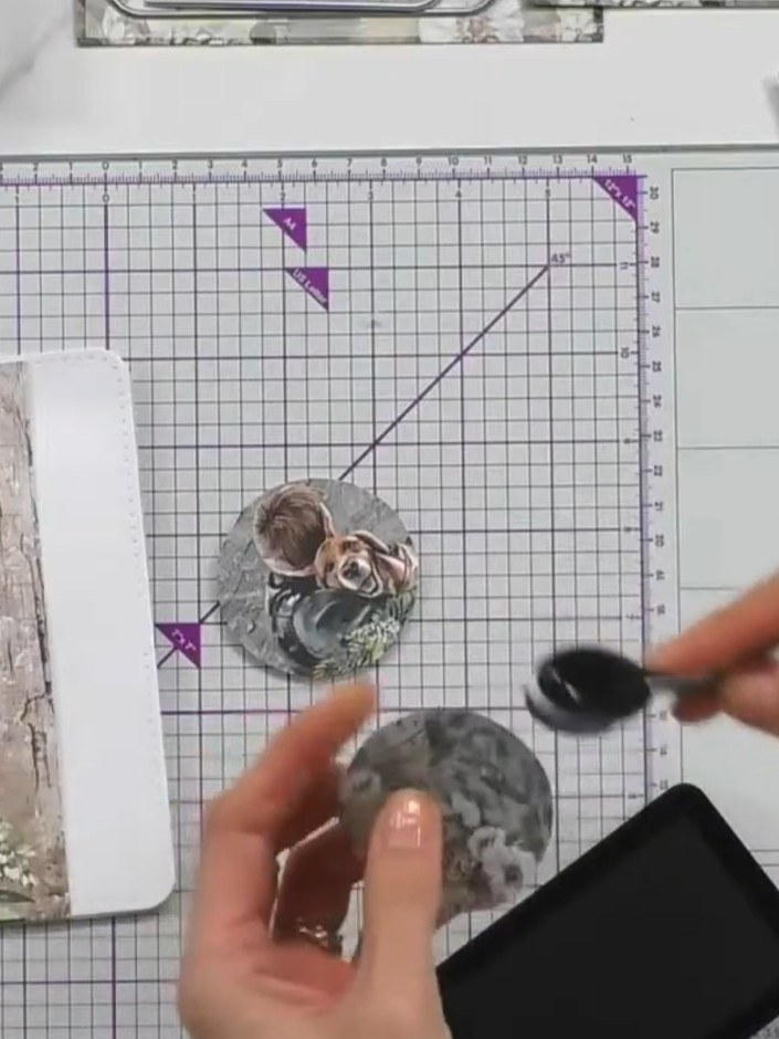 Step 5: Using a blending brush, blend black ink around the edge of one of the circular toppers to create shading and d