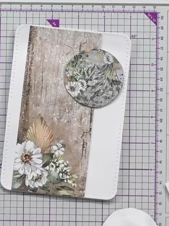 Step 3: Stick the layered circle to your card base. Position it on the decorative panel with the flowers and fan desig