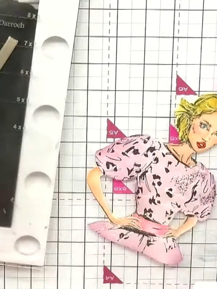 Step 10: Mount the finished dolly image onto a decorative background layer using a tape runner or glue. Position it cen