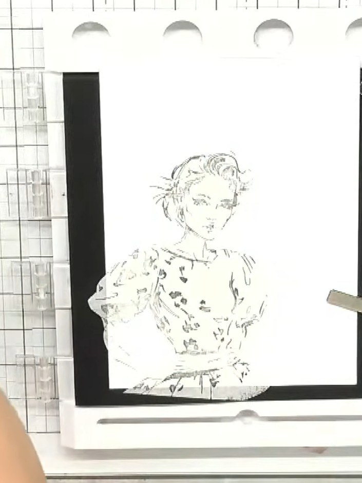 Step 3: Position the clear stamp mask over the stamped character image on your white card stock. Press down firmly to 