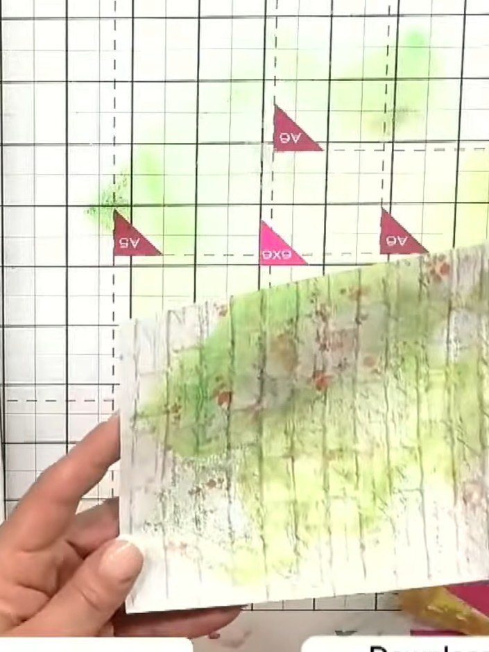 Step 10: Using a fan brush, add lustre gold confetti ink accents across the background layers of your card.