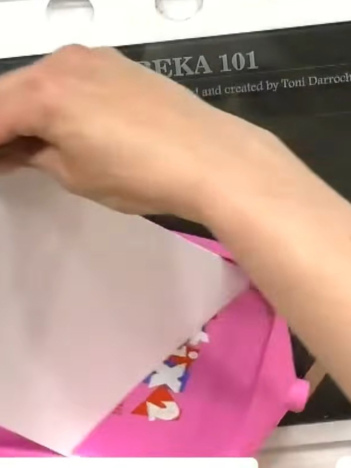 Step 2: Spray water over the inked block to create a watercolour effect. The water will blend and soften the pink ink 