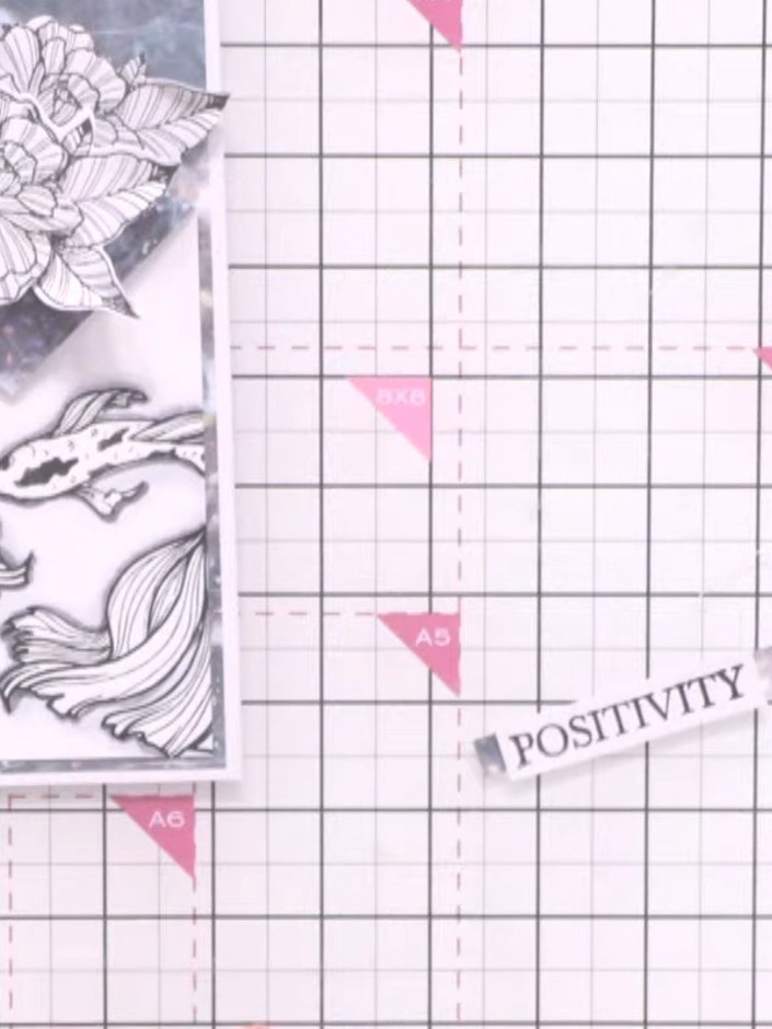 Step 11: Stamp the word 'positivity' onto white card stock using black ink. Allow the ink to dry completely before proc