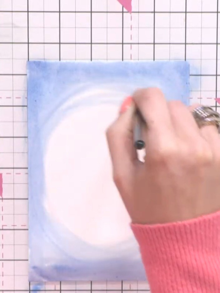 Step 3: Pull the blue colour inward from all edges towards the centre using your brush, creating an oval or circular s