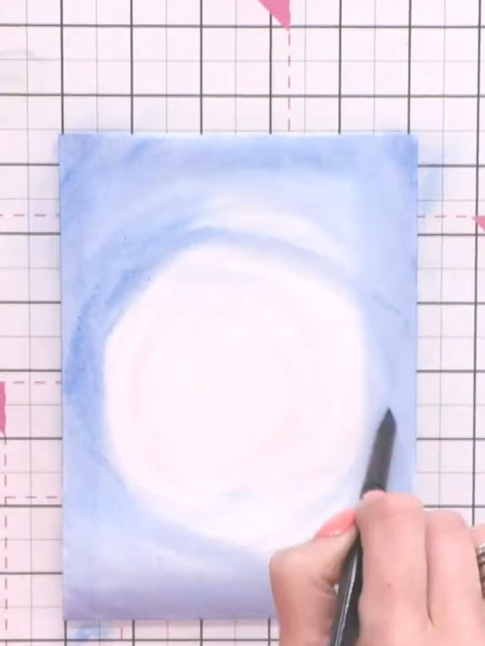 Step 4: Gently blot areas of the wet blue watercolour with tissue to soften harsh lines and create a soft, cloud-like 