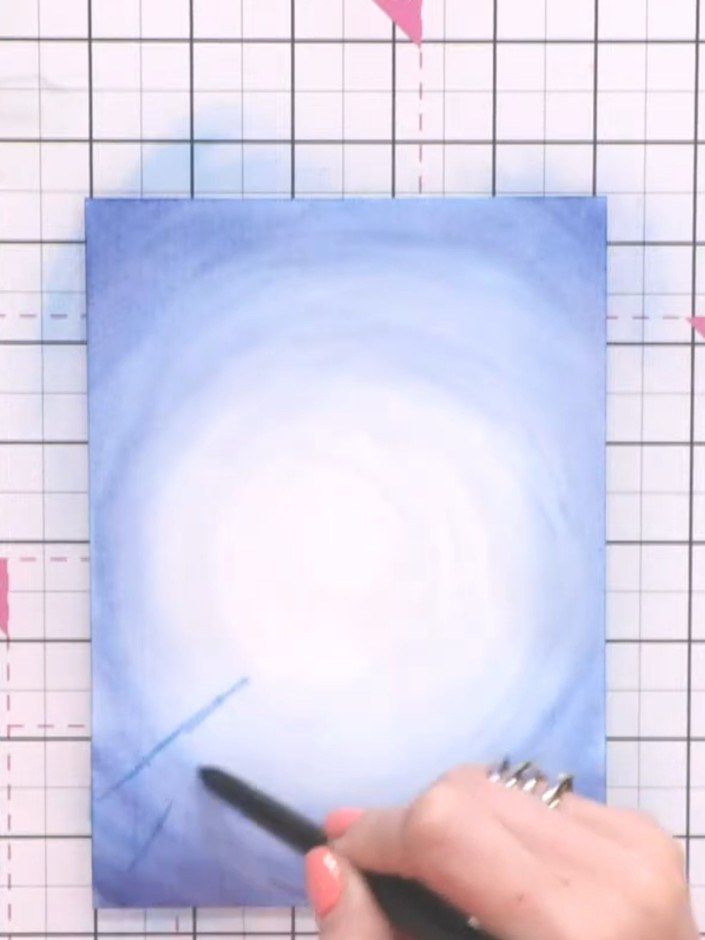 Step 6: Allow the card to dry slightly until still damp but not soaking wet. Using a smaller brush, add fine lines wit