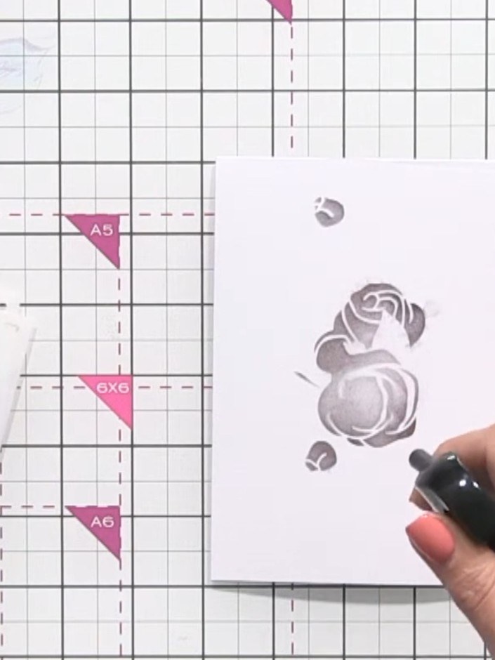 Step 4: Lightly spray the inked stencil with water to create a fizzing effect that allows the ink to bleed and spread 