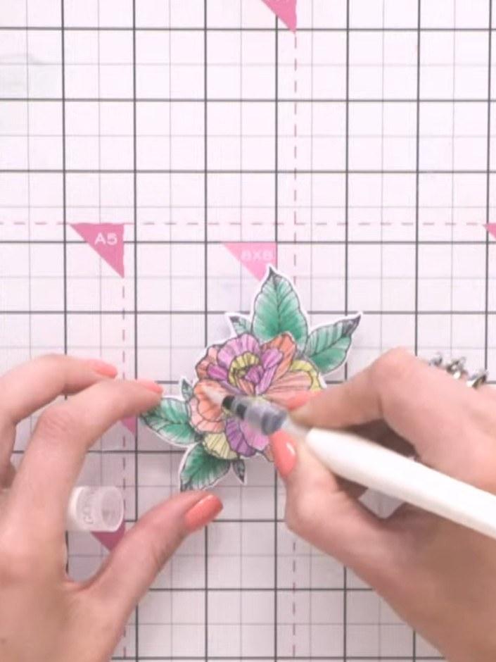 Step 14: Add sparkle details to the flower using a white sparkle pen or gel pen. Apply the sparkle to the petals and le