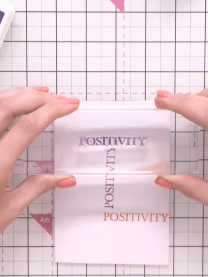 Step 5: Re-ink the word stamp with Indigo ink and stamp it again on the vellum in a different position, overlapping th