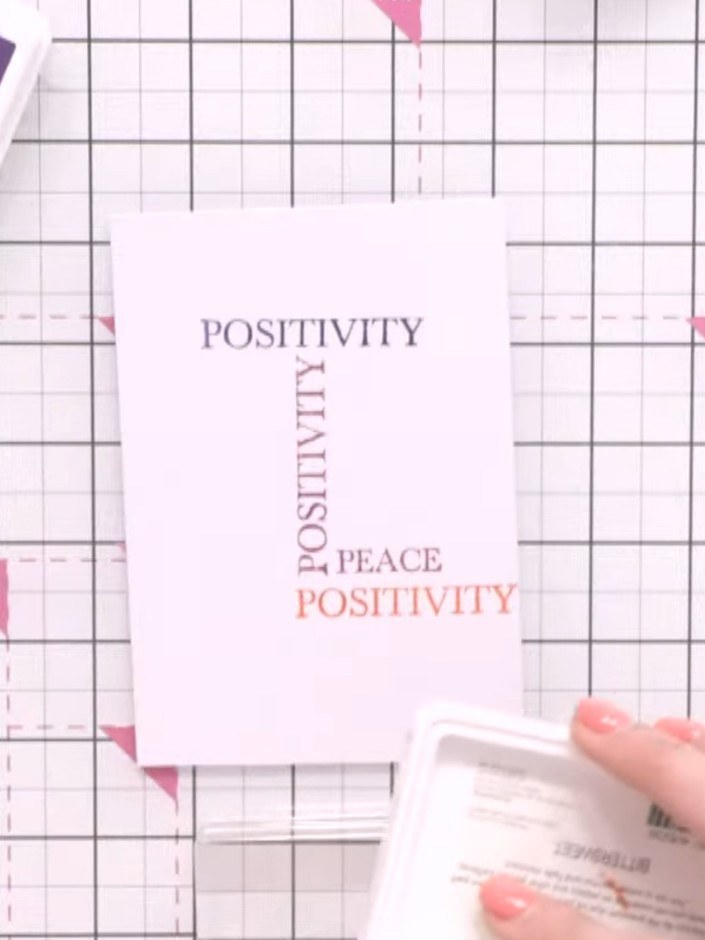 Step 7: Select the 'peace' word stamp and ink it with Bittersweet ink pad in a contrasting coral colour.