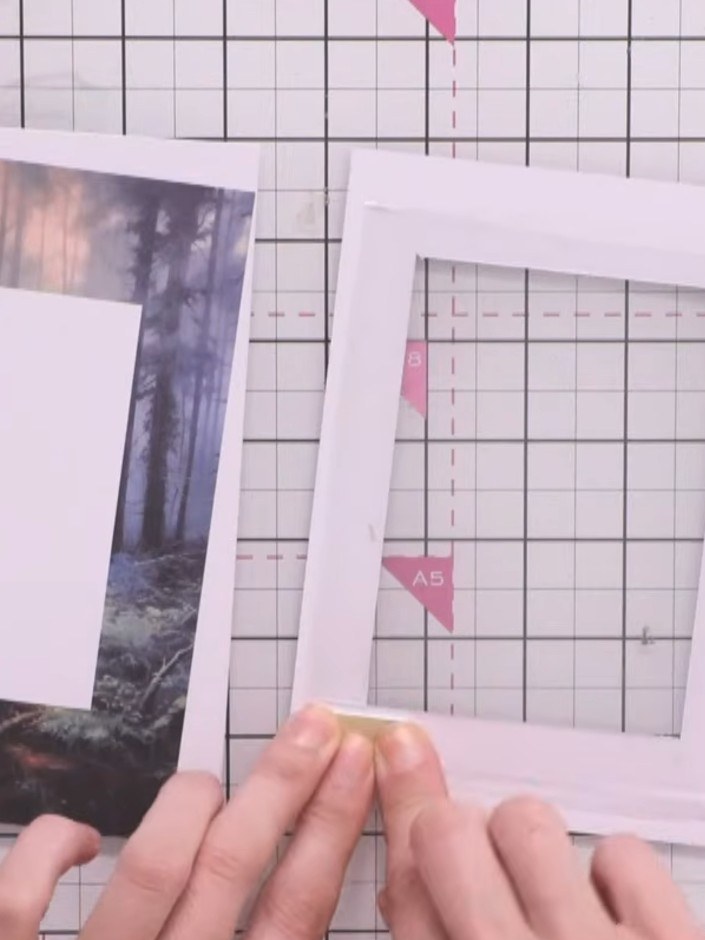 Step 9: Adhere the clear plastic window to the foam tape frame, smoothing it down carefully from the centre outwards t