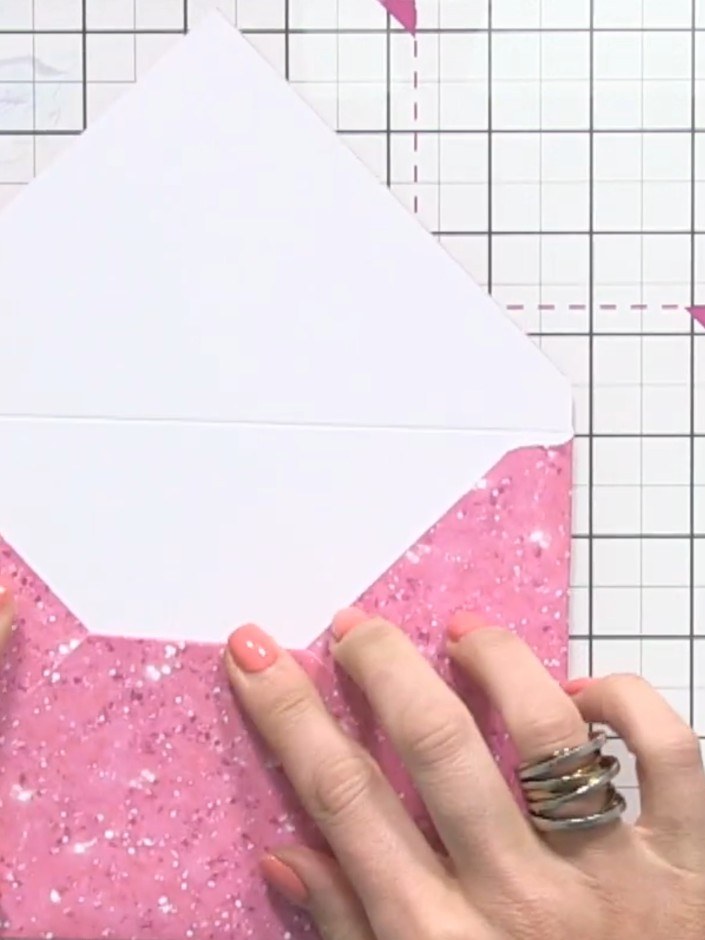 Step 8: Fold the small triangular tail inward on the pink glitter cardstock to create a neat finish at the back of the
