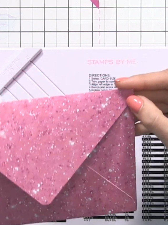 Step 1: Cut your patterned card stock to 9 by 9 inches as specified on the envelope chart. Use the pink glittery card 