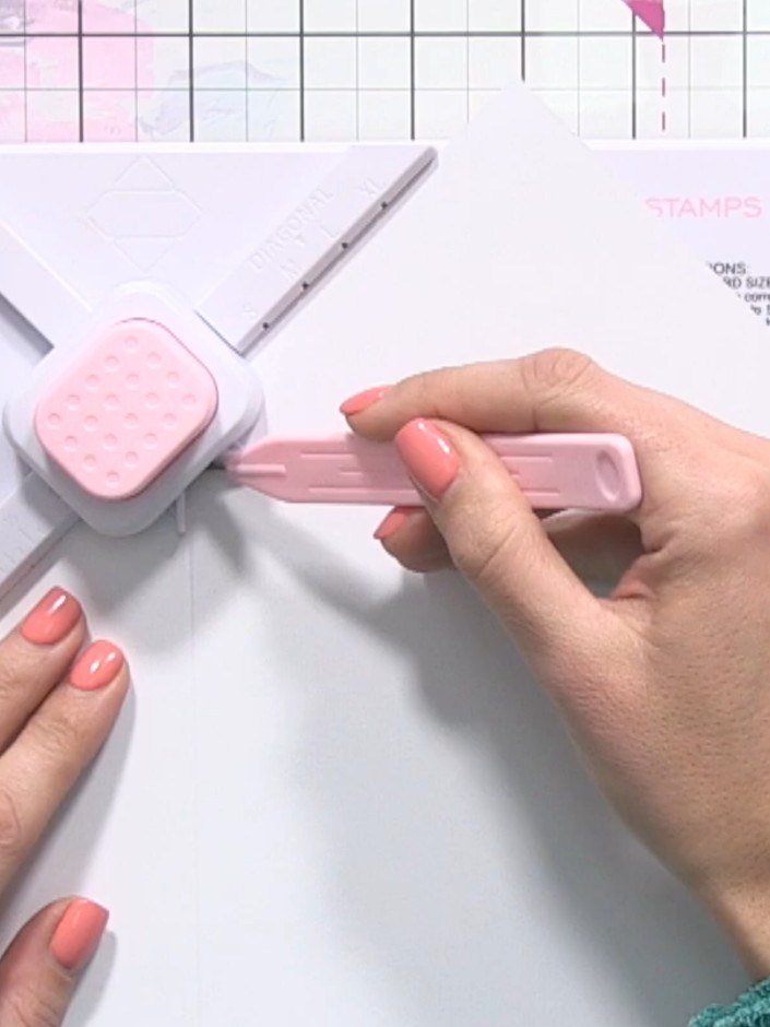 Step 3: Using the scoring tool, score your first line by following the V-shaped groove system down and across the pape