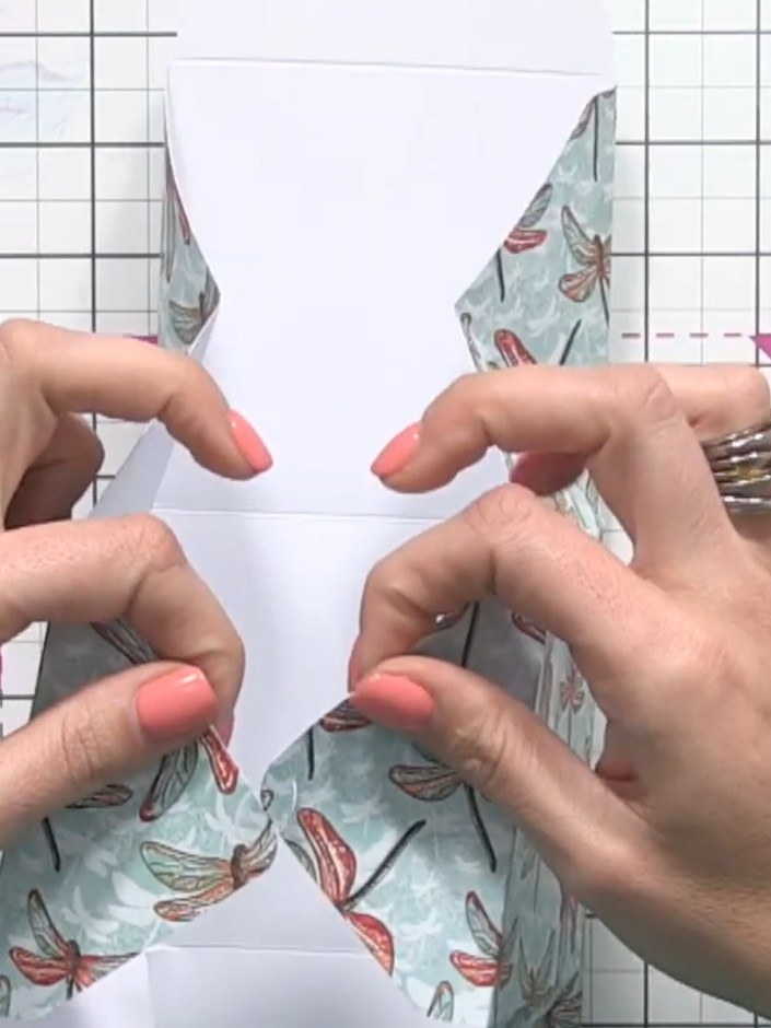 Step 10: Score the small diagonal lines by pushing the paper up and pinching along each score line to create sharp crea