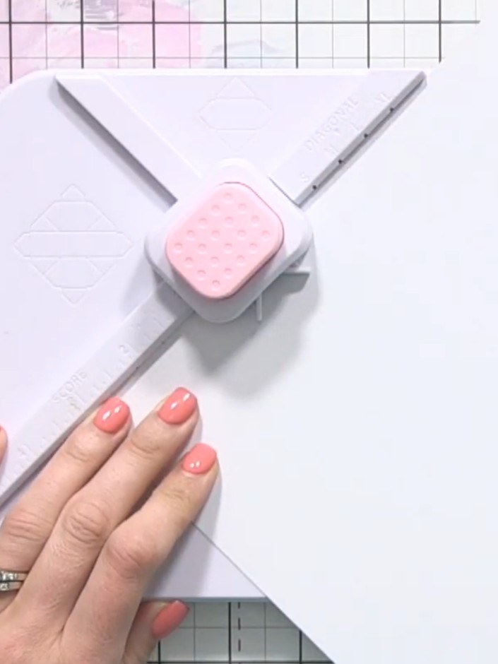 Step 2: Place your paper into the envelope maker tool and align it with the diagonal start line marked XL. Punch along