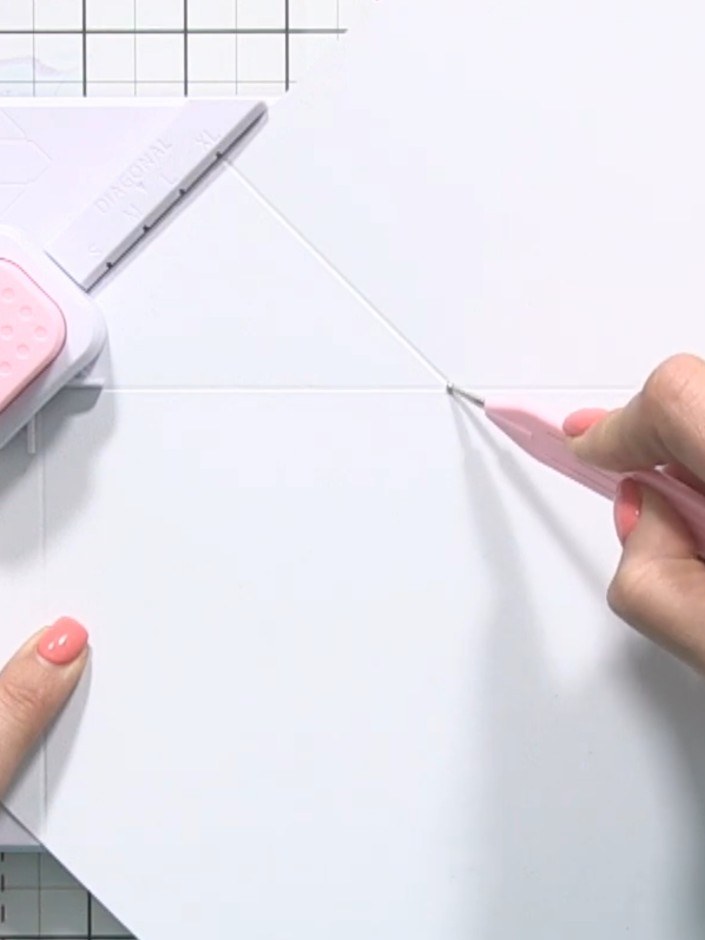 Step 3: Score down the entire length of the XL line on the envelope board, creating a fold line across the paper.
