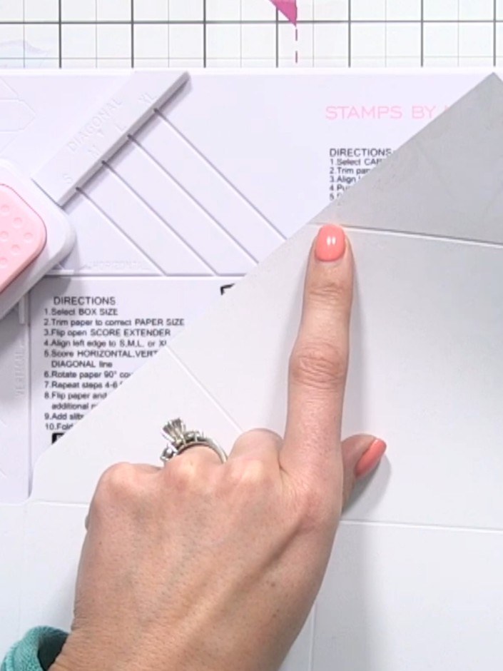 Step 7: Punch out the four small triangle pieces at alternating corners using the envelope maker tool to create neat c
