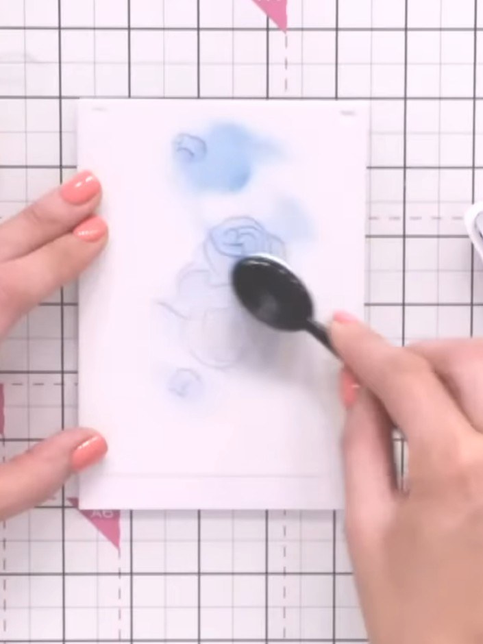 Step 4: Position stencil number two over your first layer. Apply pink or purple ink using a blending tool to build the