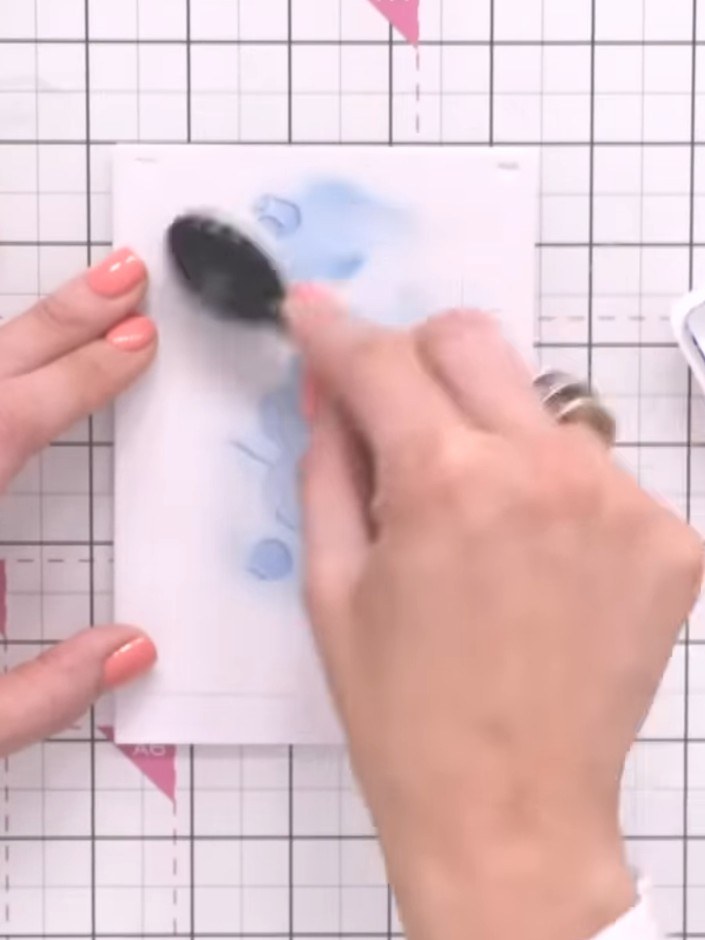 Step 5: Position stencil number three over your flower design. Apply a deeper purple ink through the stencil using a b