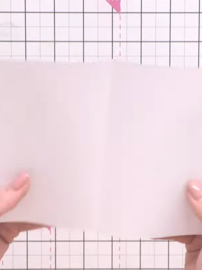 Step 2: Fold the paper in half lengthways, then unfold it and fold it in half widthways to create score lines for the 