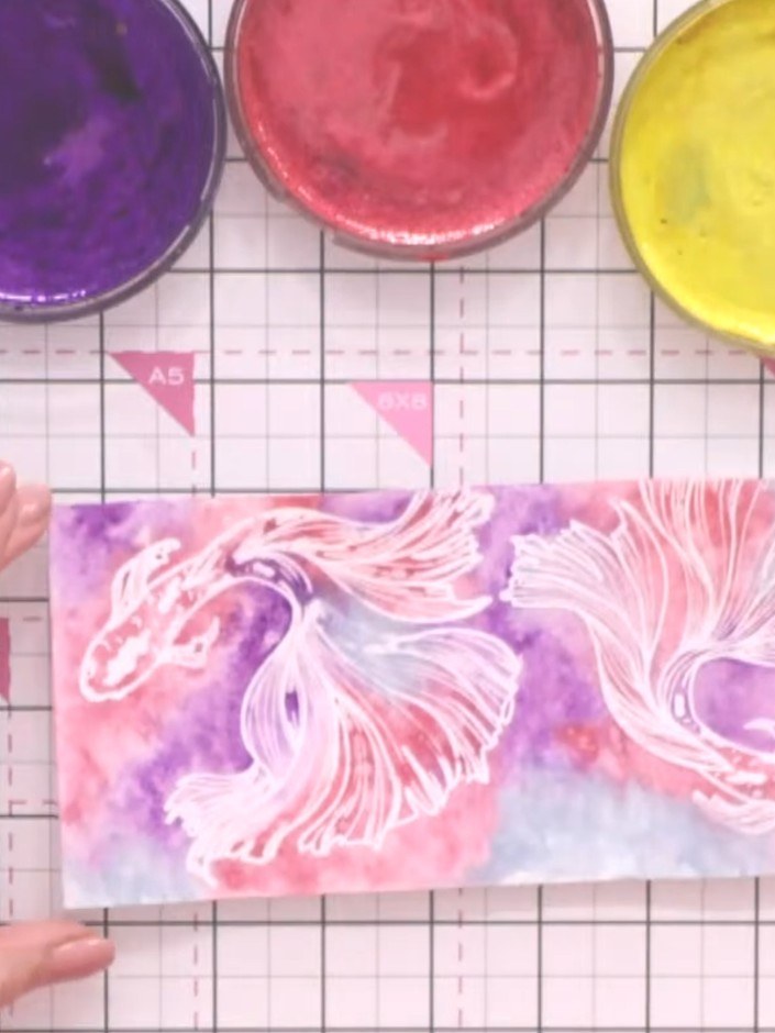 Step 12: Using a size six watercolour brush, paint the fish's tail and body with gold or metallic watercolour to bring 