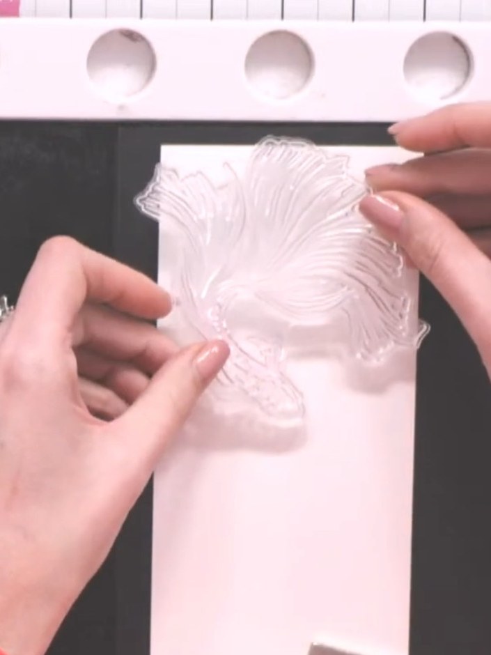 Step 2: Stamp the fish design onto the smooth side of the white watercolour card using a sticky ink pad. Position the 