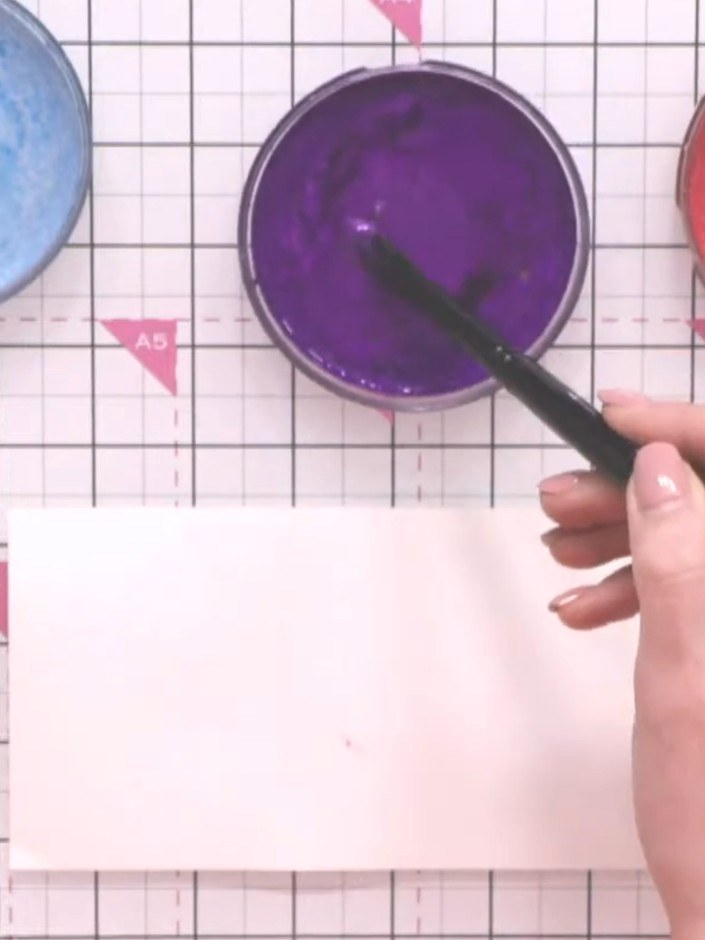 Step 7: Activate the confetti inks in three colours (bluebell, chocolat and tangerine) by spraying each with water fro