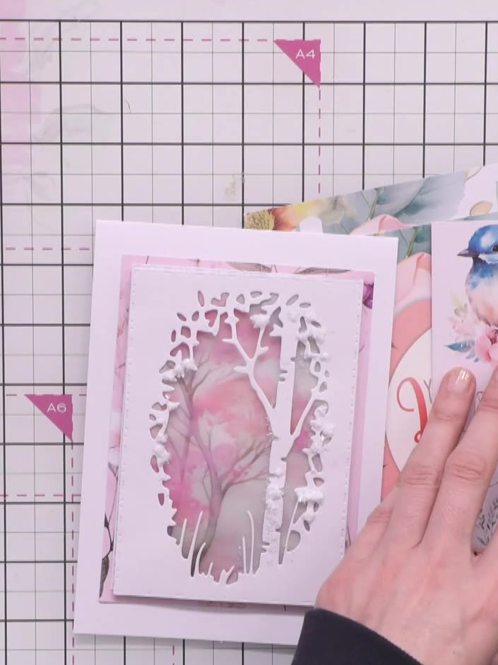 Step 3: Layer the stencils on top of the magnolia die-cut, aligning them carefully to ensure the design elements match