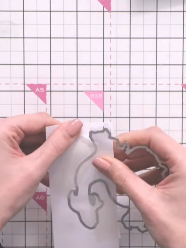 Step 6: Remove the tape and carefully separate the die-cut pieces. Keep the panel with the partial fish design intact,