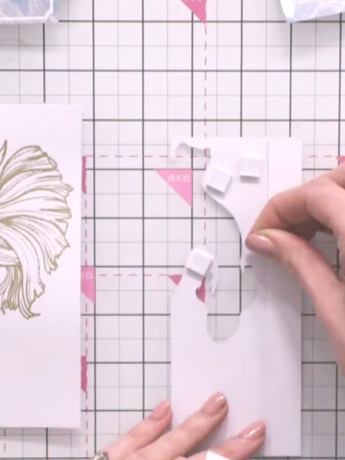Step 9: Apply small foam pads to the back of the partial fish die-cut, using smaller pieces in tight corners to create