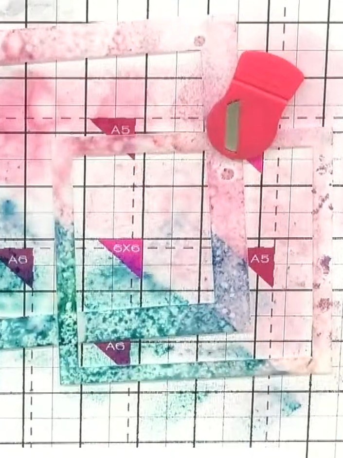 Step 3: Use a magnet to keep the stencil in position. Apply a second coordinating colour through the same stencil, squ
