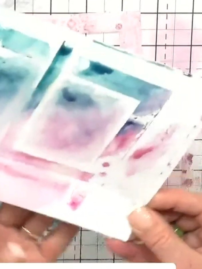 Step 5: Take a print of the blended design by pressing a piece of white cardstock onto the wet ink on the glass mat. L