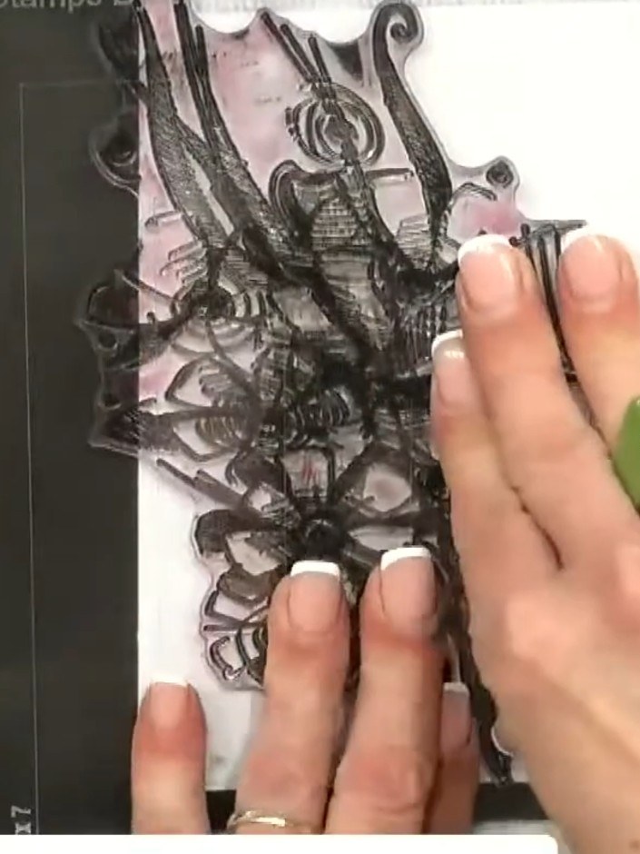Step 3: Carefully peel away and remove the mask from the card to reveal the stamped doll image with the floral overlay