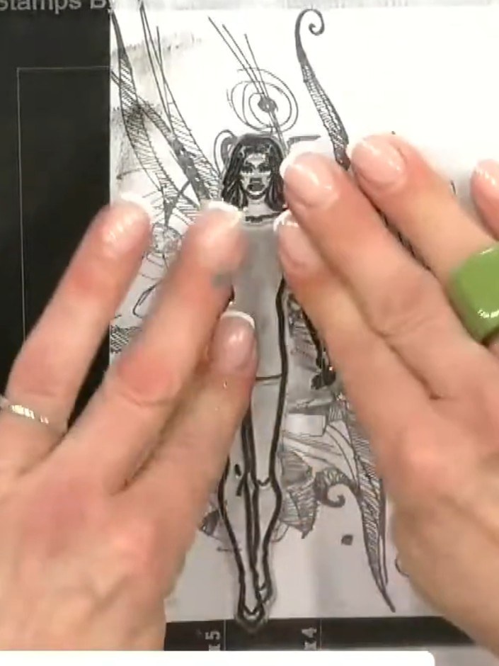 Step 5: Position the cut-out fairy doll figure onto a piece of decorative paper with abstract patterns. Layer the stam
