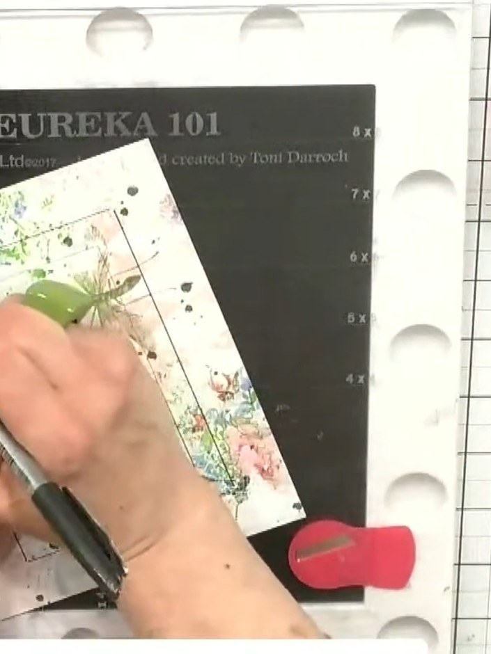 Step 4: Carefully lift and remove the stencil from the card to reveal the pen-drawn frame border underneath.