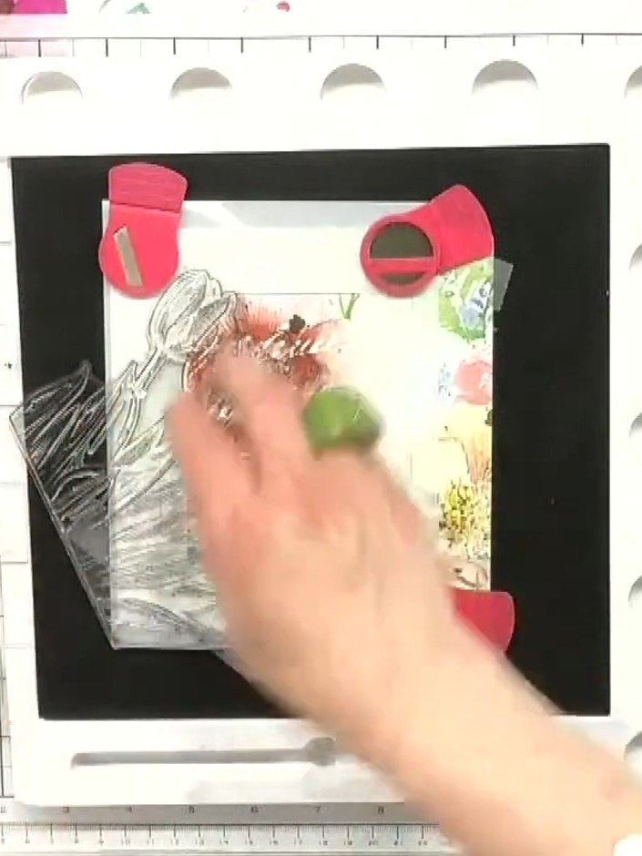 Step 2: Using embossing ink, stamp the tulip detail stamp through the stencil frame onto the floral panel. Apply four 