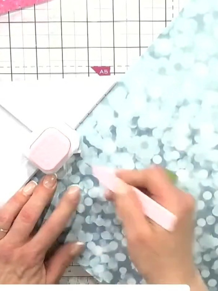 Step 4: Use the envelope and box tool's three punch options to create notches in the blue patterned paper. First use t