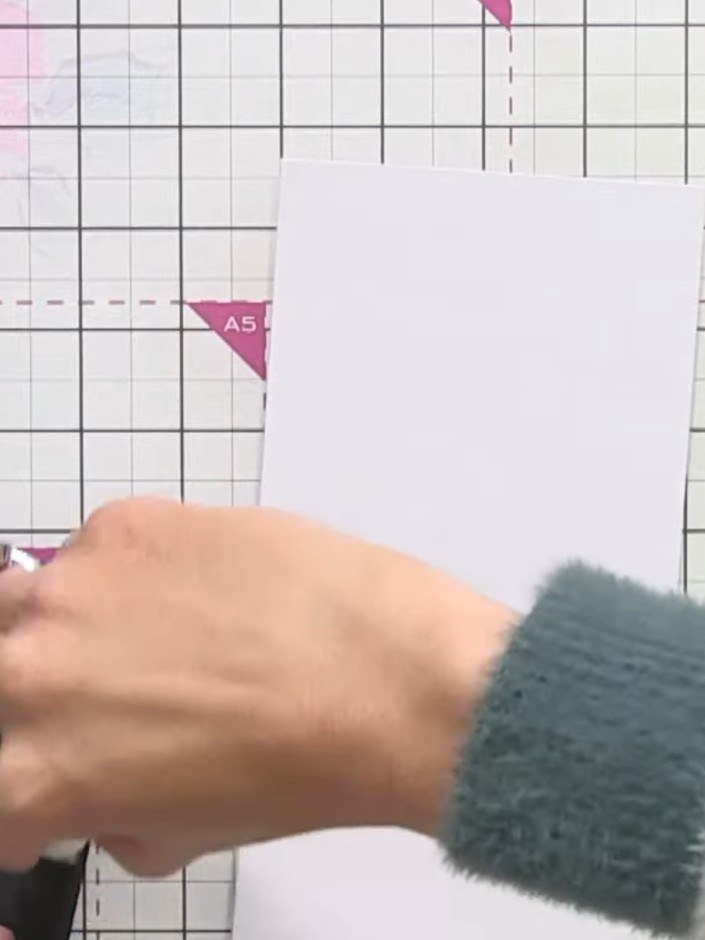 Step 13: Using black ink and an applicator, swipe around the edges of the white card base to create a border frame effe