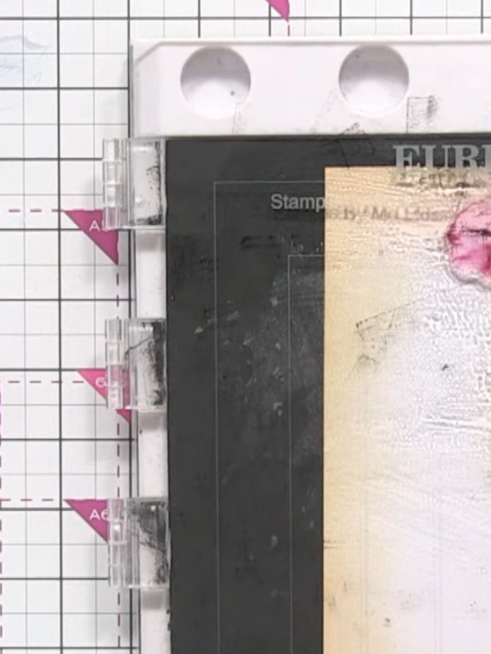 Step 7: Press the stamp firmly onto the card and hold it in place, allowing the water and pink ink to transfer onto th