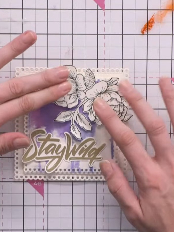 Step 13: Attach the fussy-cut floral piece to the top of the card using a small amount of adhesive to create dimension.