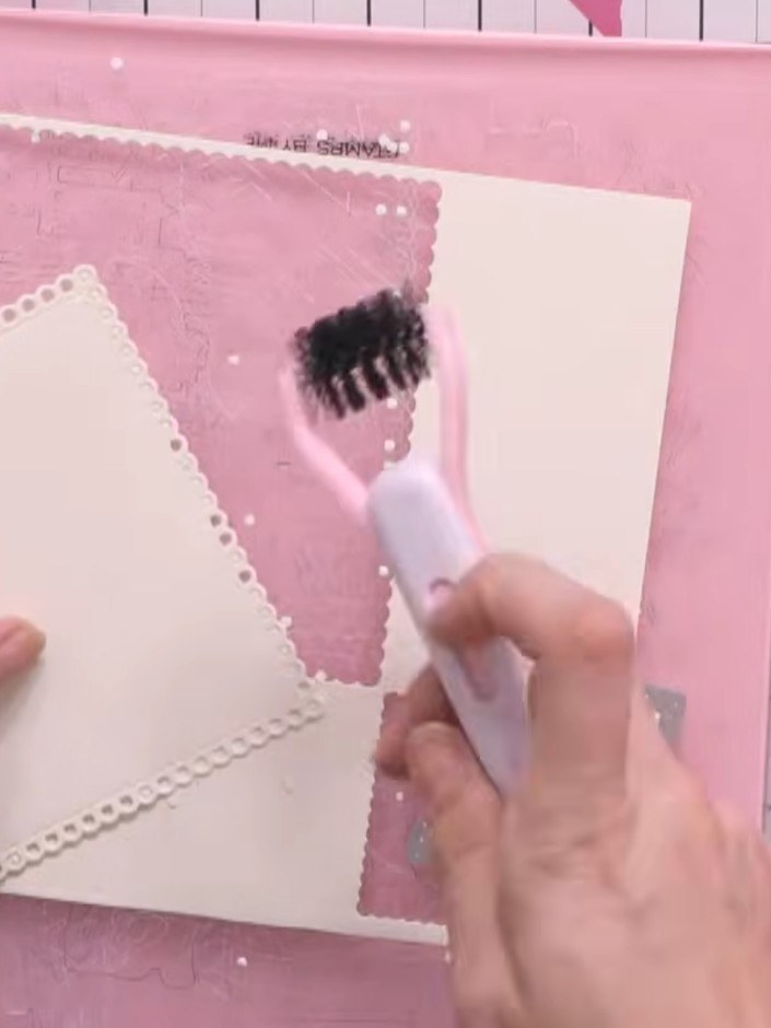 Step 3: Apply glue to one of the largest die-cut squares using the glue brush. Place a second largest die-cut square o